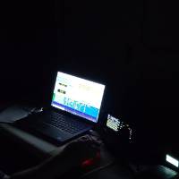 Student tests radio on computer in the dark